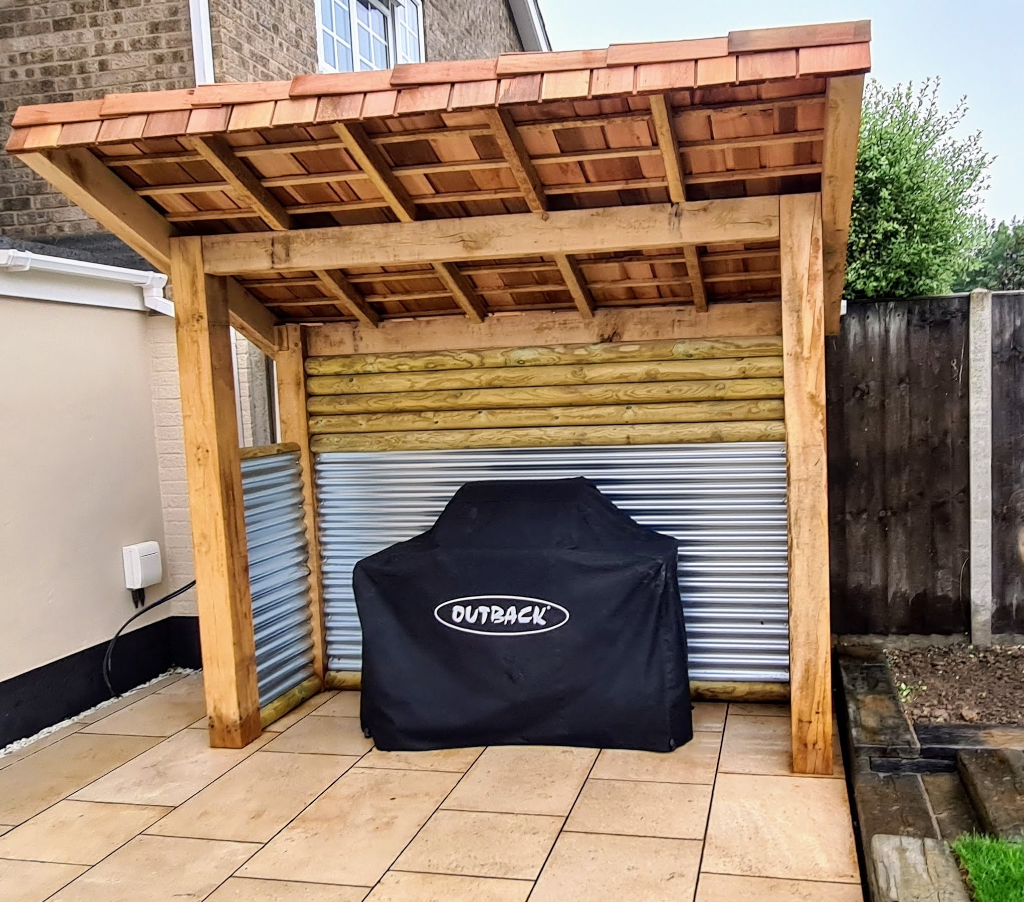 Oak framed barbecue shelter on a sandstone patio