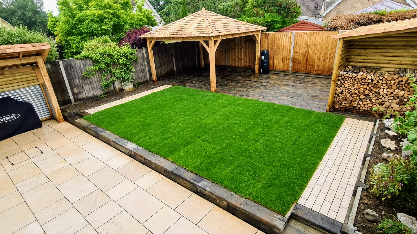 A finished garden by Project Landscaping: oak gazebo, log store, new lawn and a porcelain patio